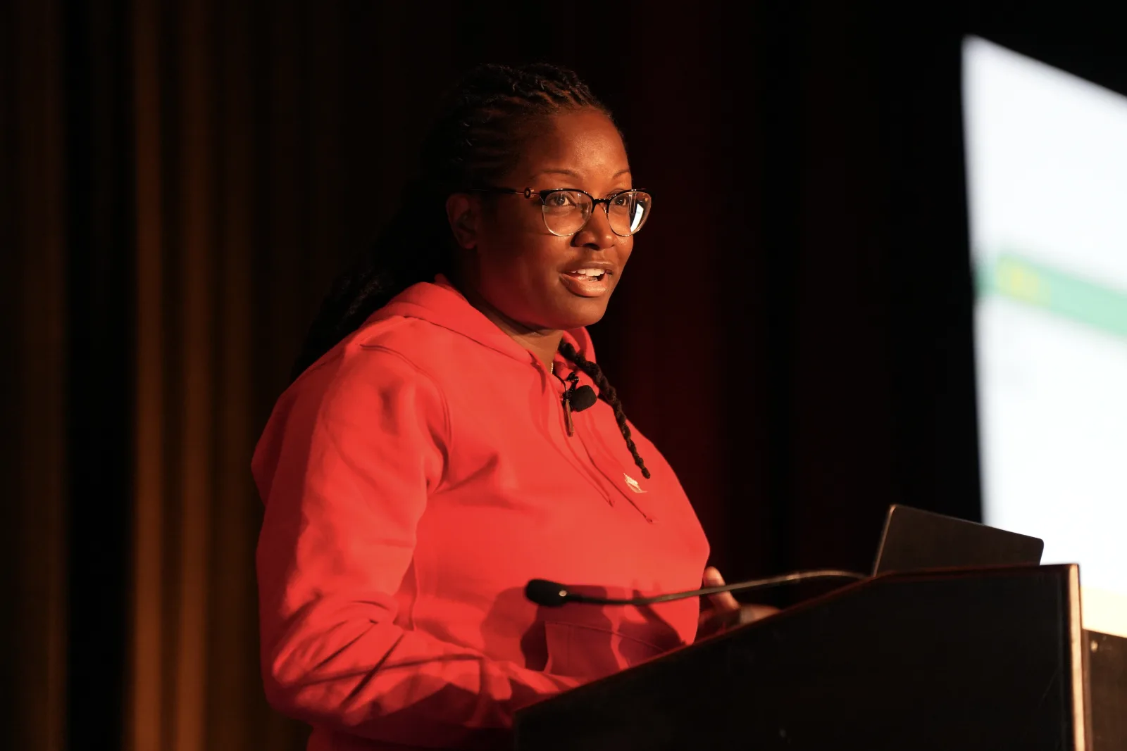 Danielle Lewis speaking from a lectern at a technology conference