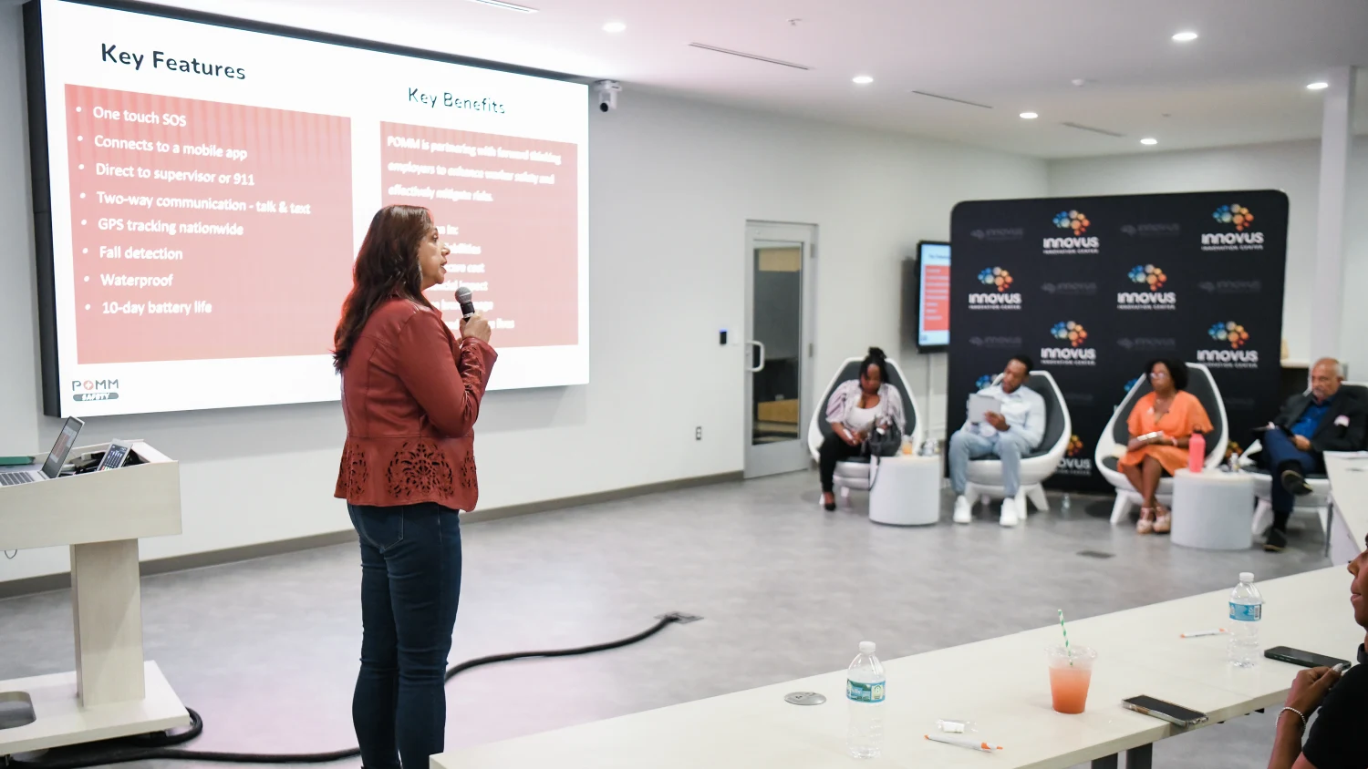 A founder presenting her slides to the room at the 2024 pitch competition