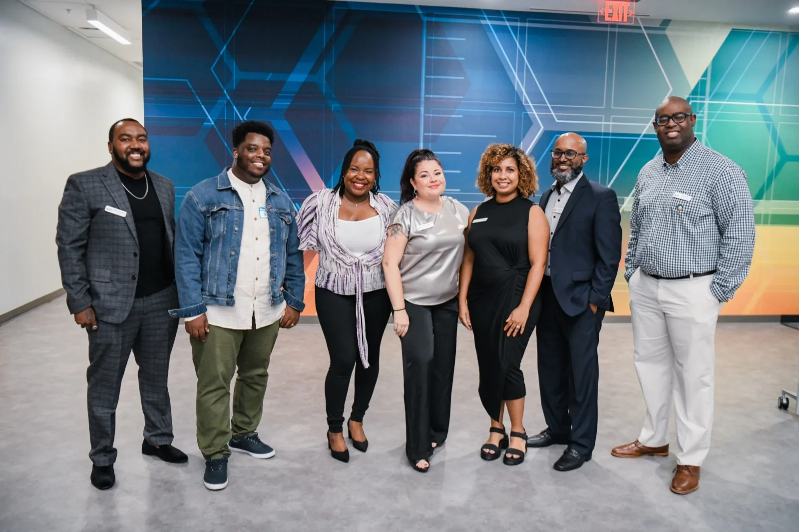 The Building Our Tech team together in front of the mural at their Orlando office