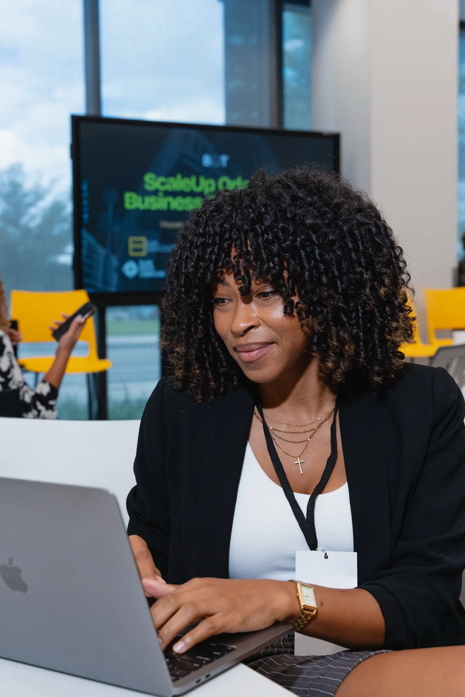 A participant working on a laptop at the ScaleUp Orlando Business Conference