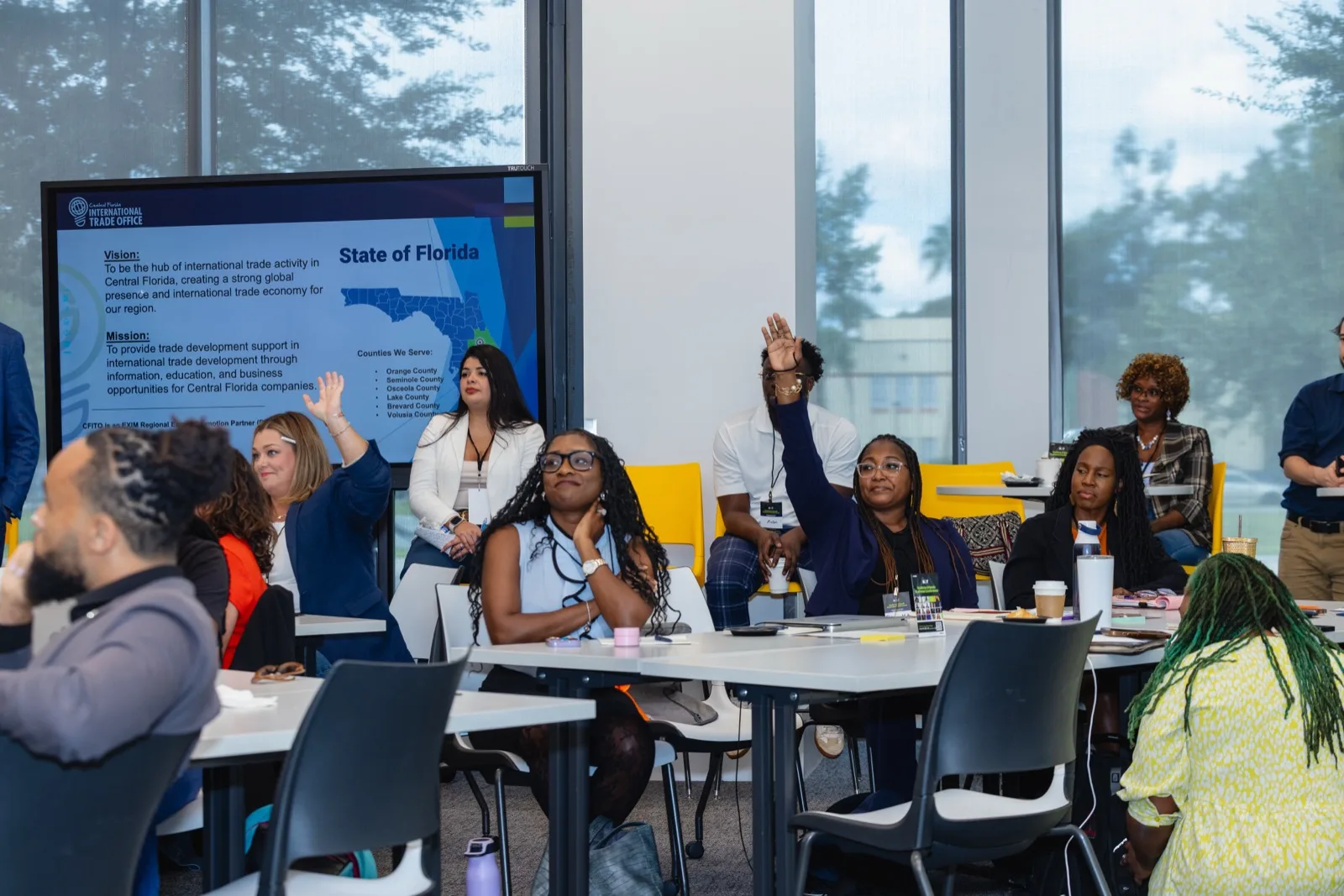 Participants raising their hands during a session at a Building Our Tech event