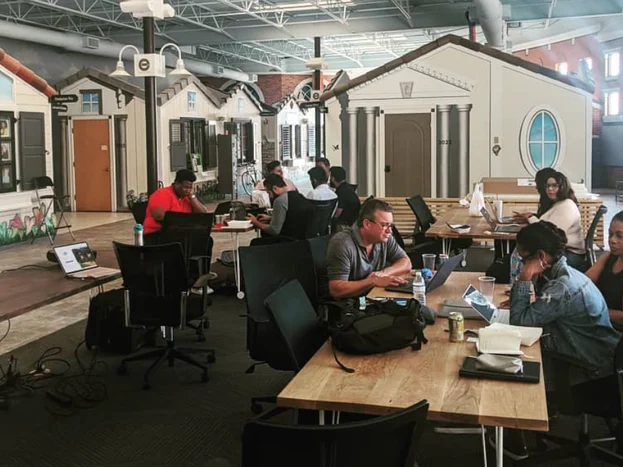 Volunteers at laptops around long tables, rebuilding the Wells&rsquo; Built Museum&rsquo;s website and systems