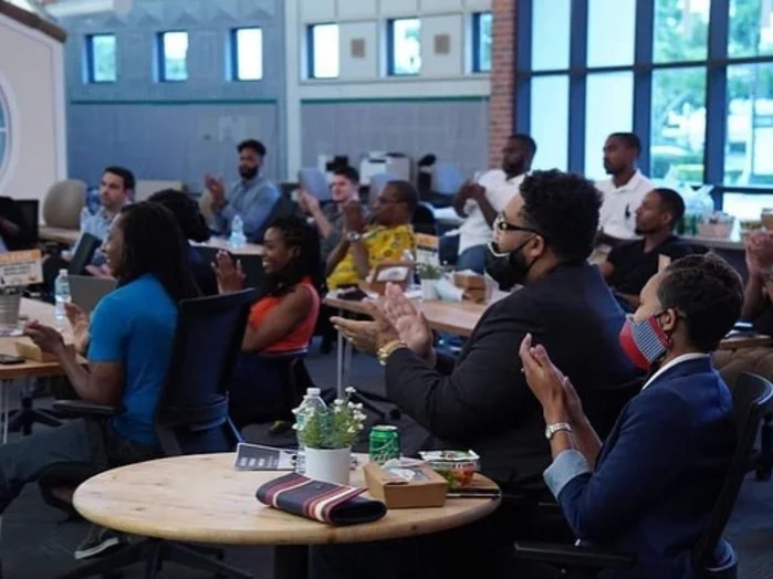 A full room of guests at round tables during the Black Tech Founders Showcase